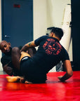 BJJ Rash Guard in Black with Death Cuddles in action 1