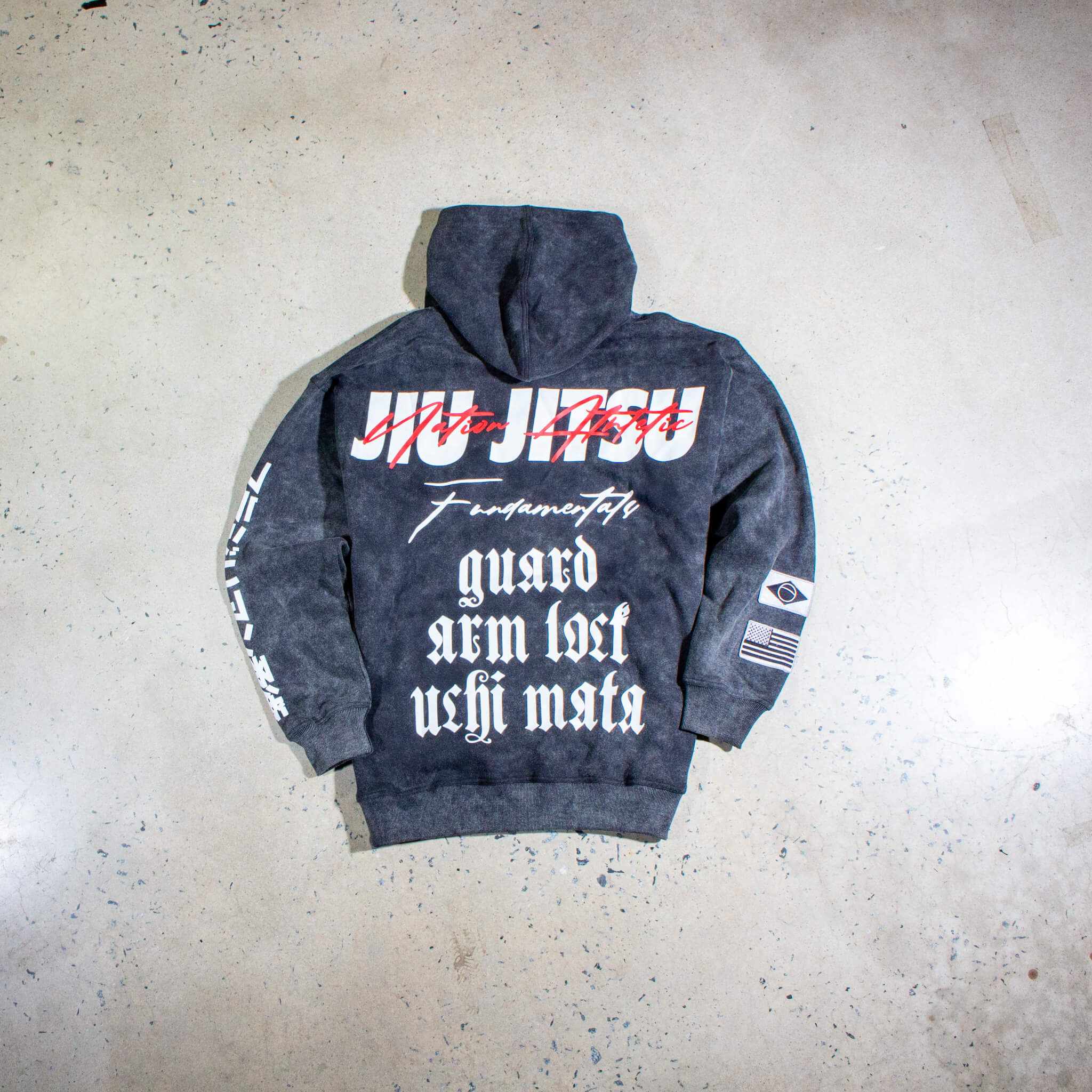 Black acid wash BJJ hoodie with bold Jiu-Jitsu graphics, showcasing grit and durability for combat enthusiasts.