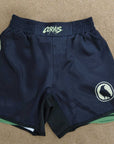 Navy blue shorts with logos on a beige surface