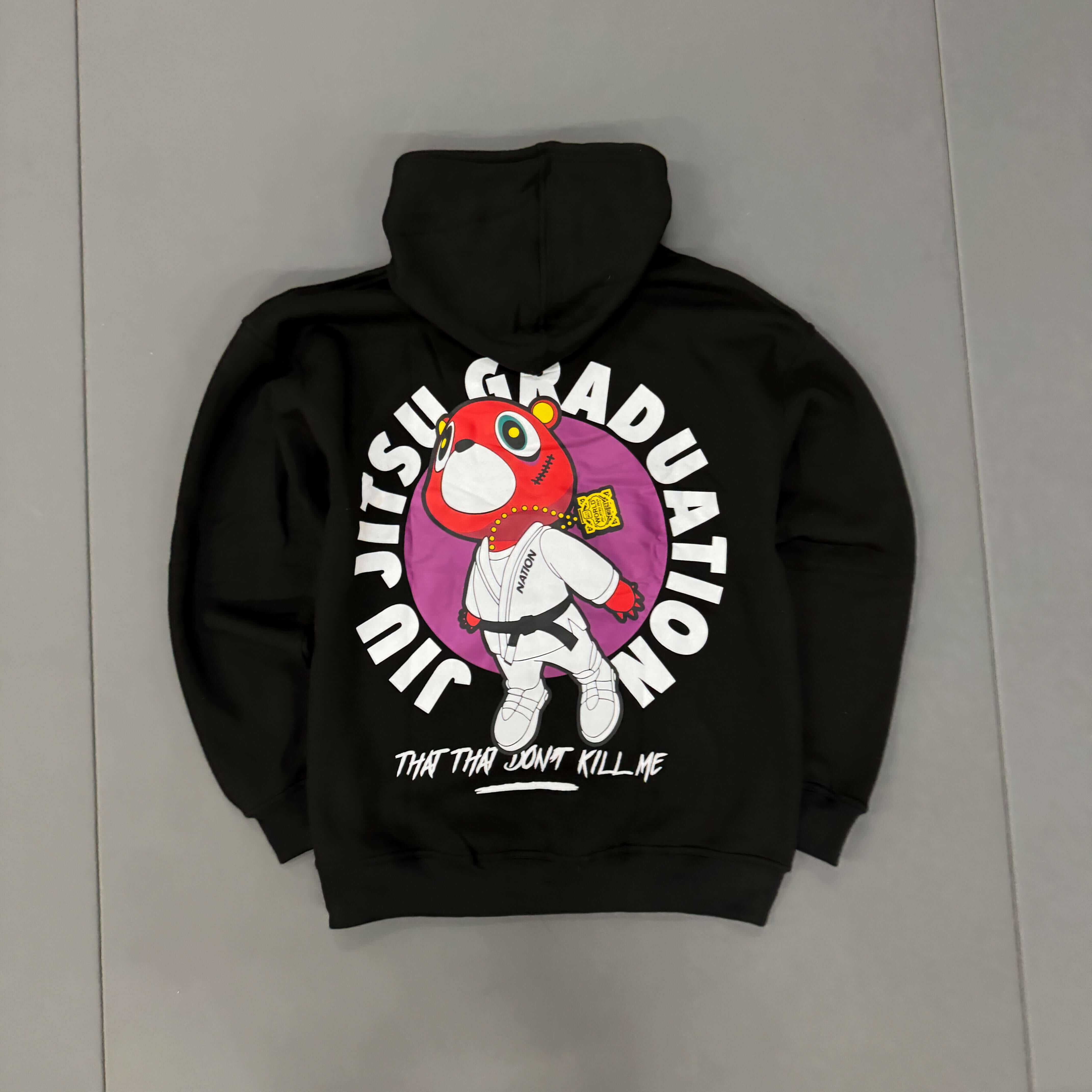 Black Kanye BJJ Hoodie with oversized fit featuring colorful cartoon bear in jiu-jitsu gi and bold "Jiu Jitsu Graduation" text on back