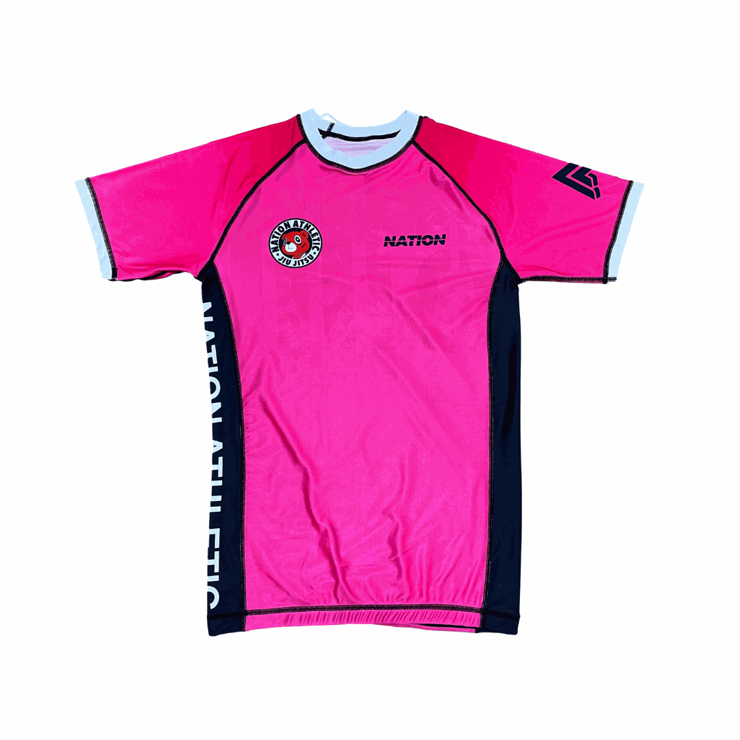 Pink athletic shirt with branding on a white background