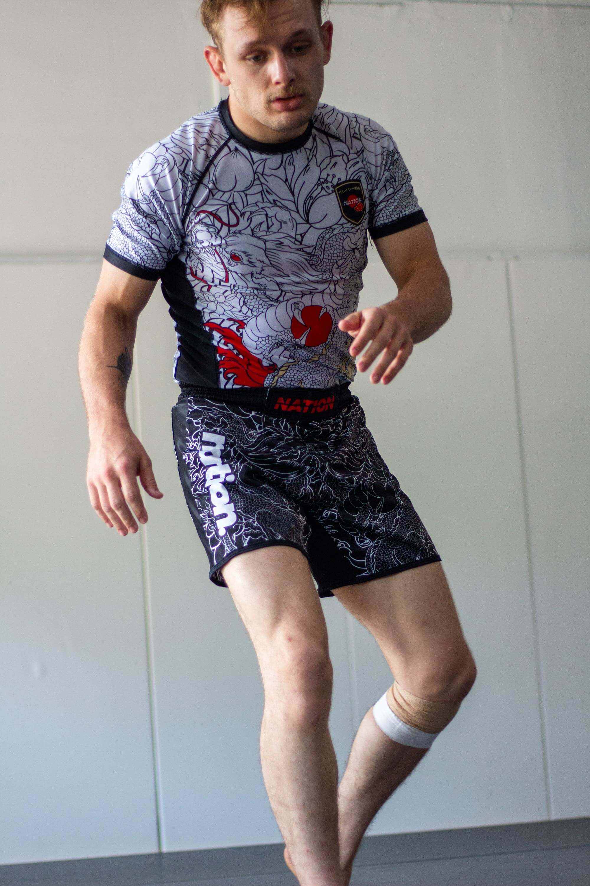 White short sleeve BJJ rash guard with Rising Dragon design for No-Gi Jiu Jitsu and MMA.