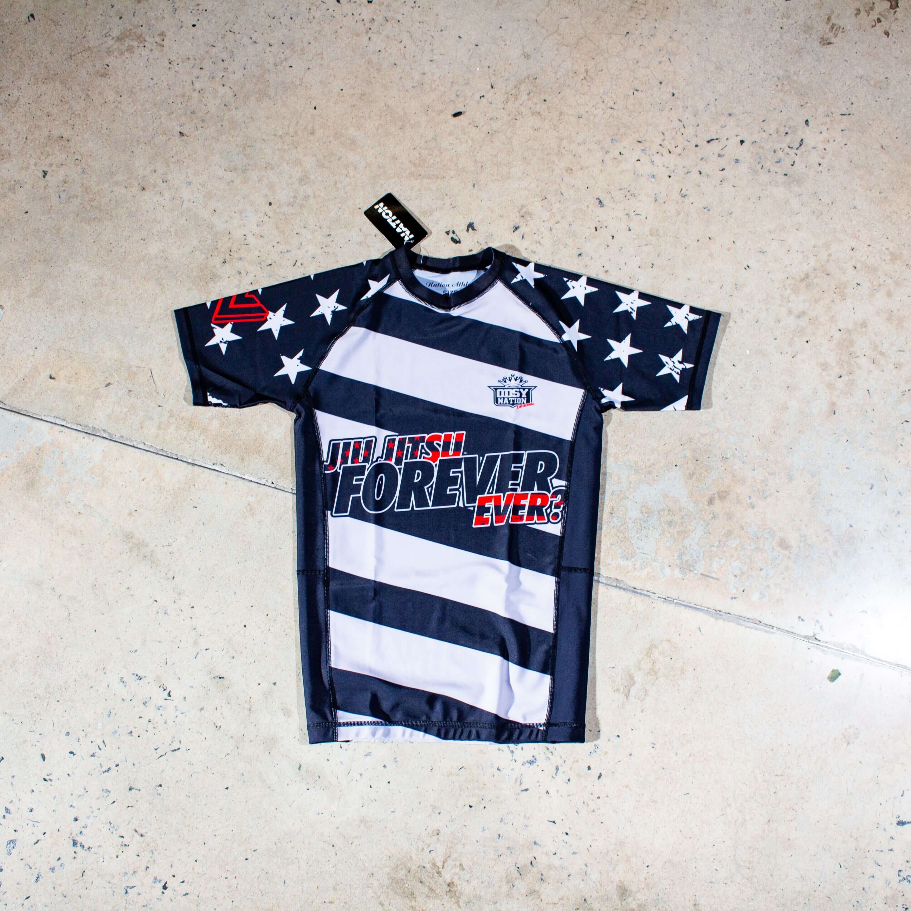Limited edition Odyssey Invitational BJJ rash guard with striped design, featuring durable spandex/polyester mix, for No-Gi grappling and MMA.
