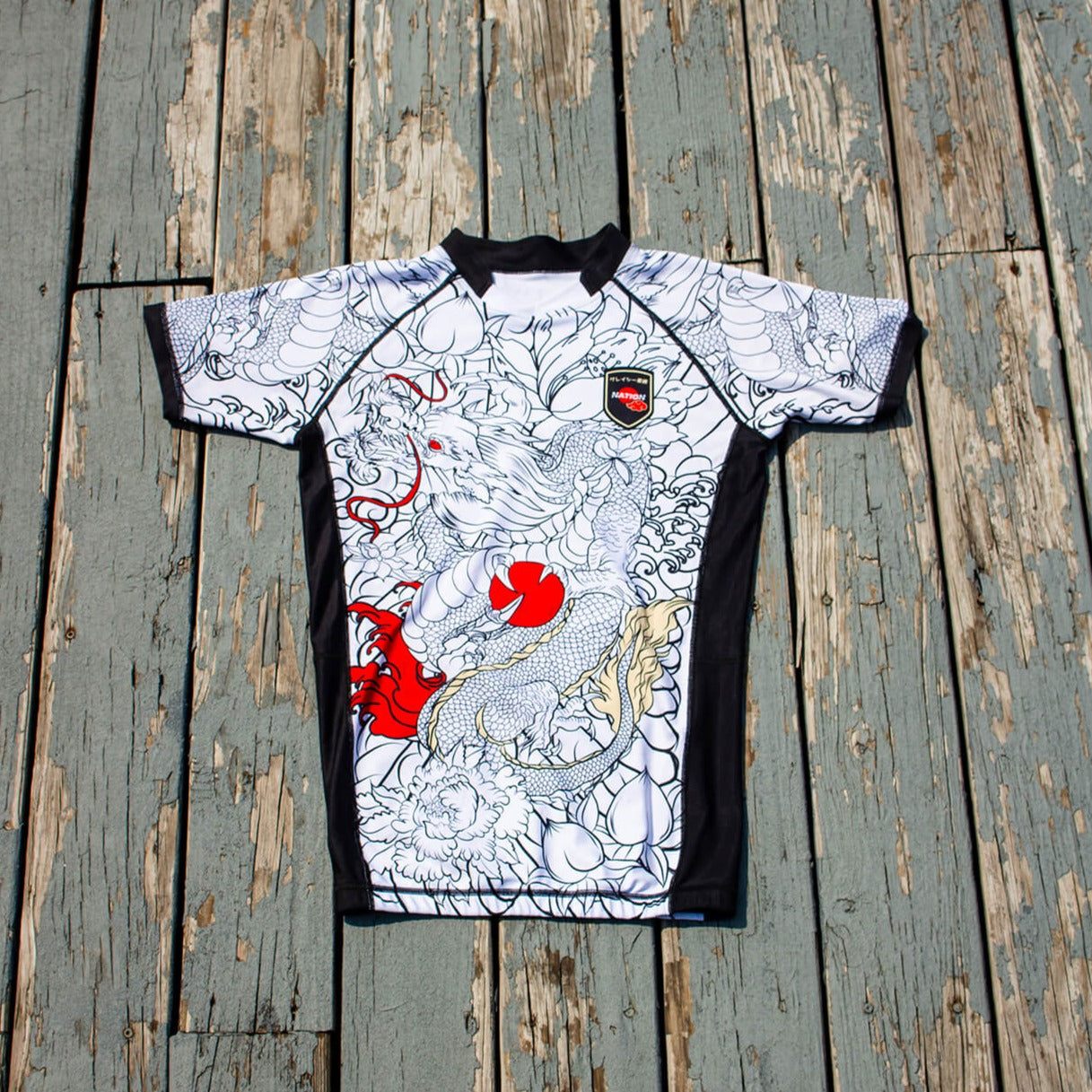Kids BJJ Rash Guard, Rising Dragon design, white short sleeve, durable spandex/polyester, youth size.