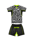Black and white sports jersey with green accents and 'NATION' branding on shorts against a white background