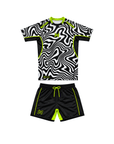 Black and white patterned shirt with green accents and black shorts with green accents on a white background