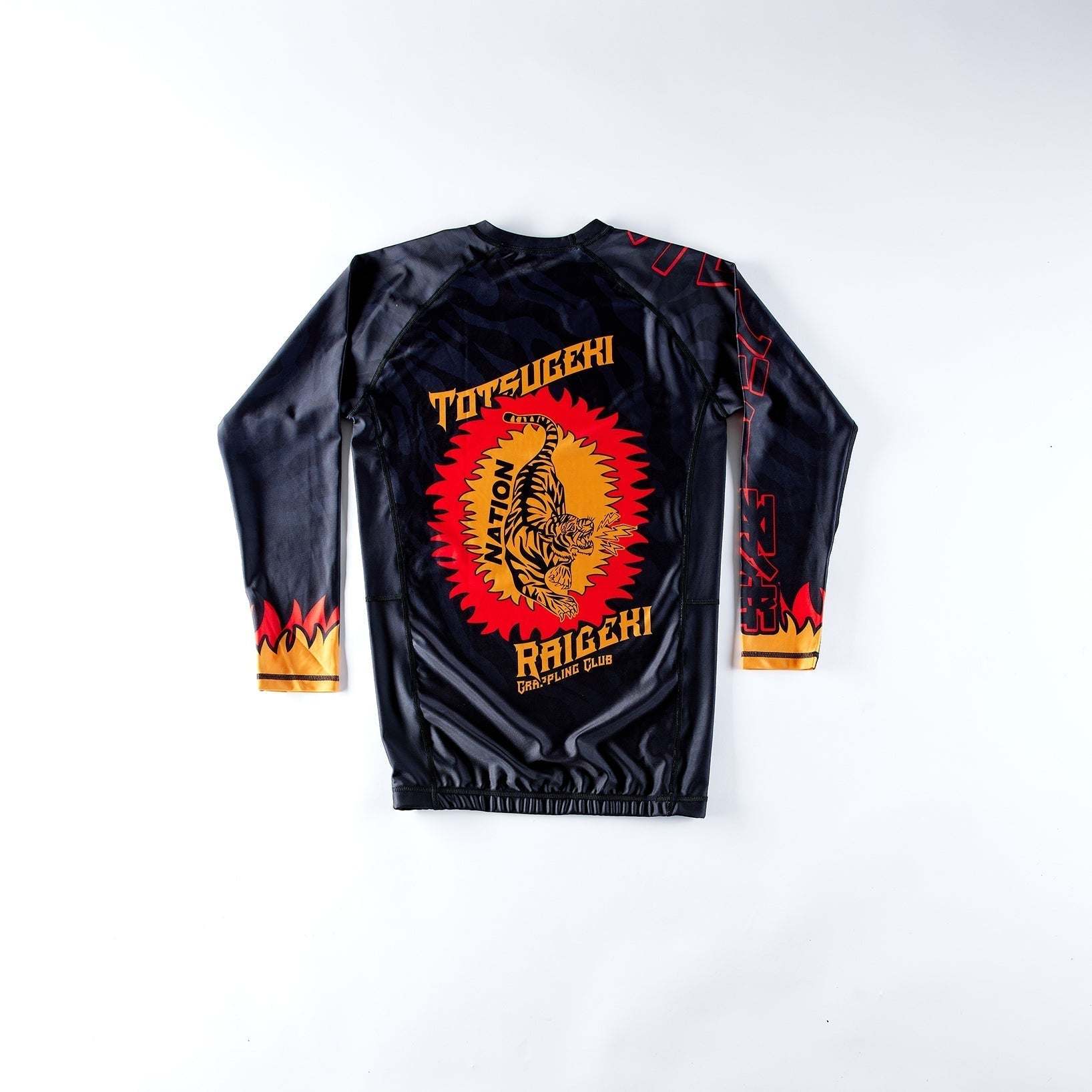 Black Totsugeki Raigeki BJJ rash guard featuring tiger design for high-performance grappling.