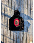 Black Totsugeki BJJ Hoodie with screen-printed design, ultra-soft fleece, on wooden background.