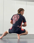 Cucuy Hunter BJJ Rash Guard Set with skull design, featuring a man in crouched position on a mat.