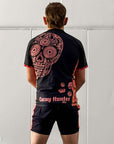 Cucuy Hunter BJJ Rash Guard Set featuring Tex-Mex-inspired design with skull artwork on back, black and red color scheme, short sleeves, and matching grappling shorts.