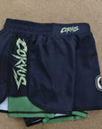 Pair of navy blue shorts with green lining and 'Corvus' branding on a beige background