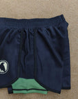 Navy blue shorts with a logo on a beige surface