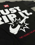 Black BJJ T-shirts with white and red text and graphics on a gray surface