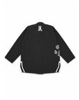 A black long-sleeve bjj gi jacket shown from the back, featuring a white stylized 'N' logo on the upper back, white graphic prints on the right sleeve, and white piping along the side seams, set against a plain white background.