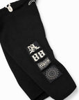 Black Brazilian jiu jitsu kimono pants featuring three rectangular graphic patches on the lower leg, including a stylized '88' patch, a Parental Advisory label patch, and a circular 'Cult Classic' patch, shown against a plain white background.