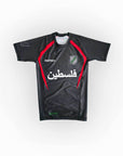Black sports jersey with red accents and Arabic text on a white background