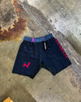 Black BJJ grappling shorts with pink accents, elasticated waistband, four-way stretch fabric, and mid-thigh length.