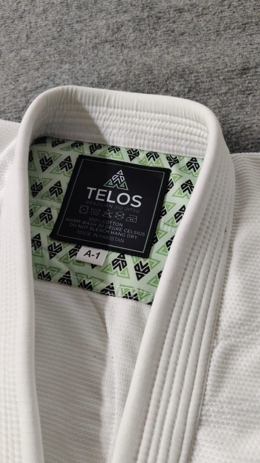 Close-up of custom BJJ gi collar, branded label and sublimated lining