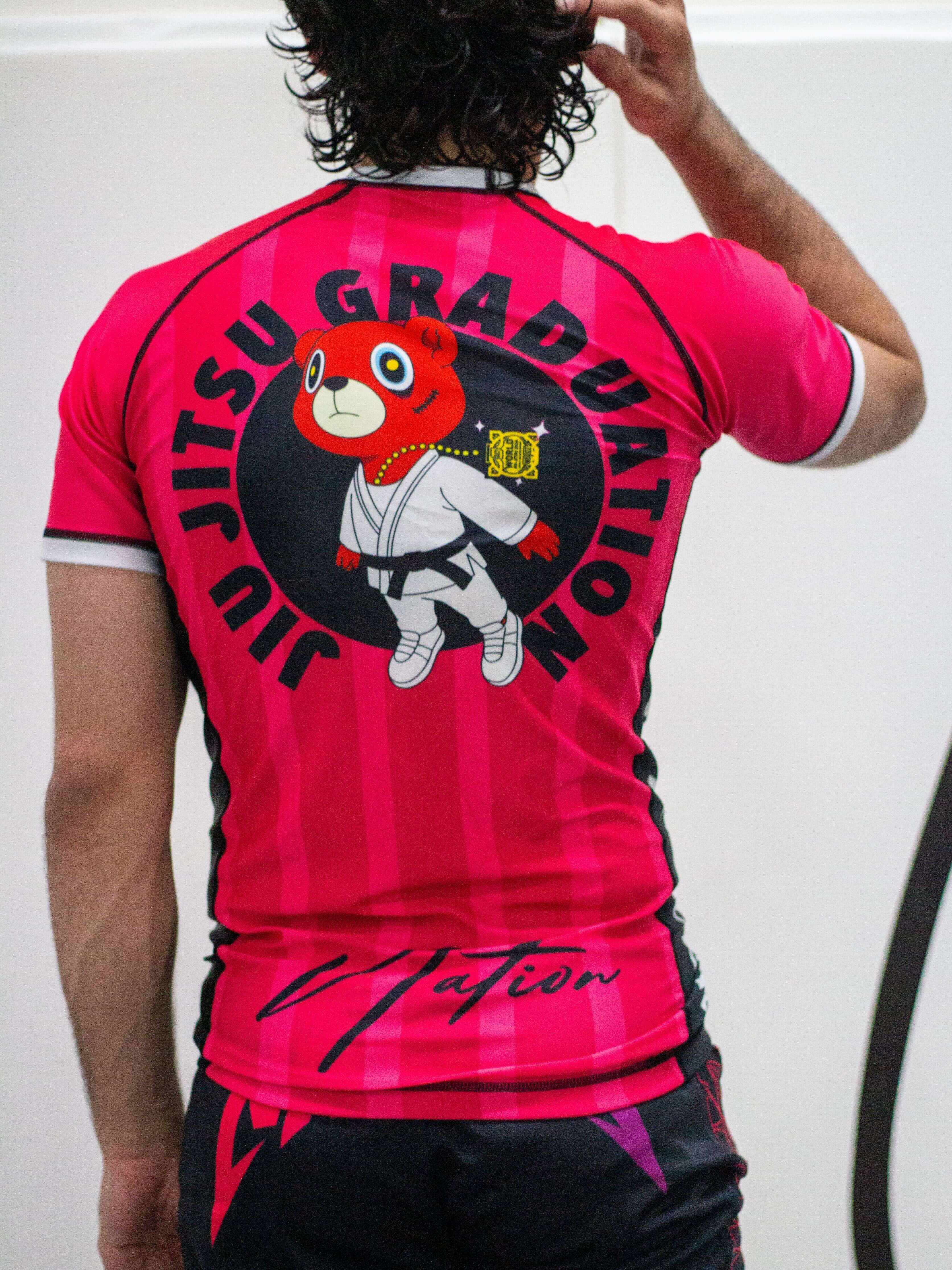 Pink Rash Guard with a bear logo at the back