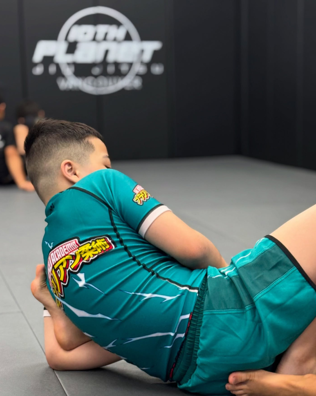 A kid wearing a no-gi set while in training