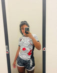 Woman wearing Rising Dragon BJJ Nogi Set in white with dragon design taking a mirror selfie