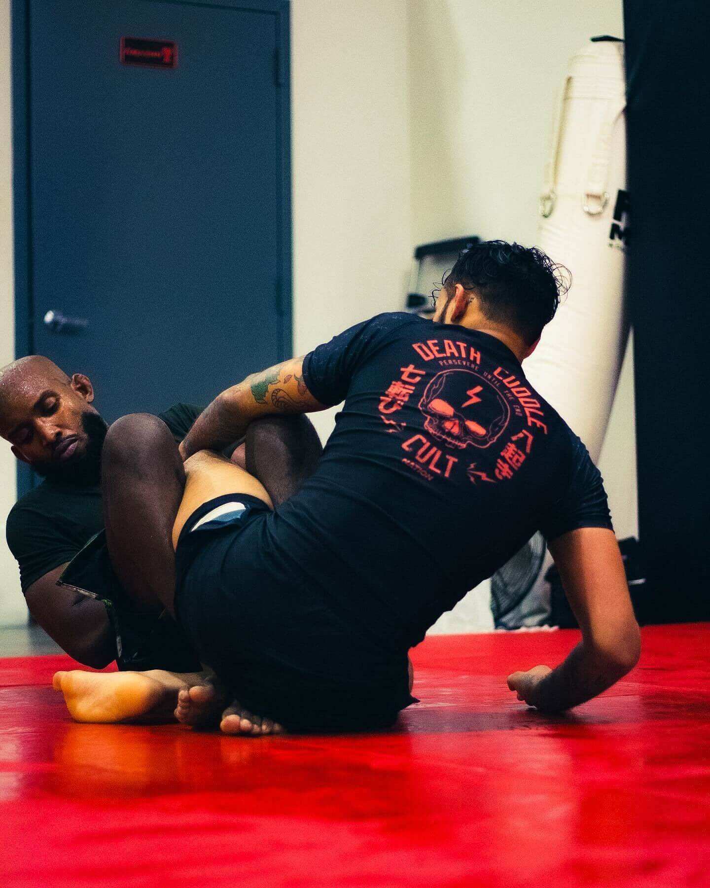 BJJ Rash Guard in Black with Death Cuddles in action 1
