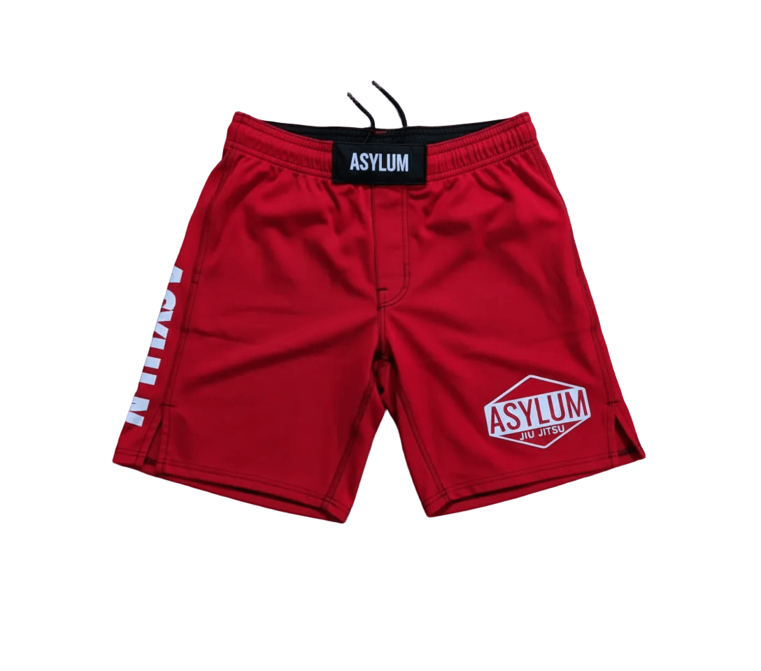 Red shorts with 'Asylum' branding on a white background