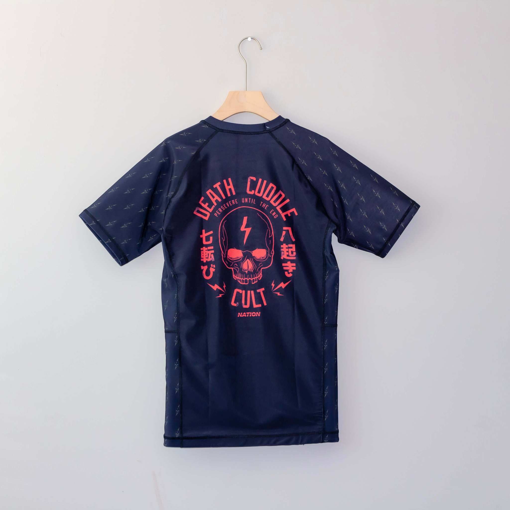 Death Cuddles rash guard compression fit close up flat lay 