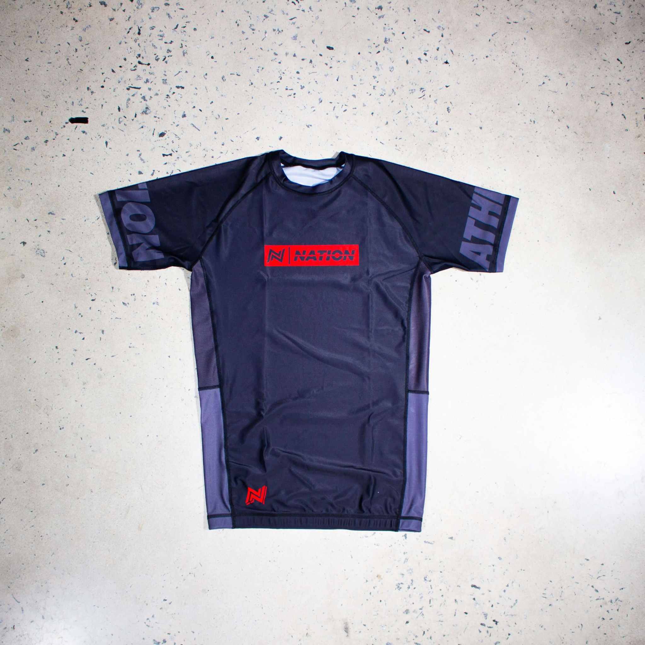 Black short sleeve Jiu Jitsu Essentials BJJ rash guard, lightweight and durable no-gi fight wear, featuring reinforced stitching and breathable mesh panels.