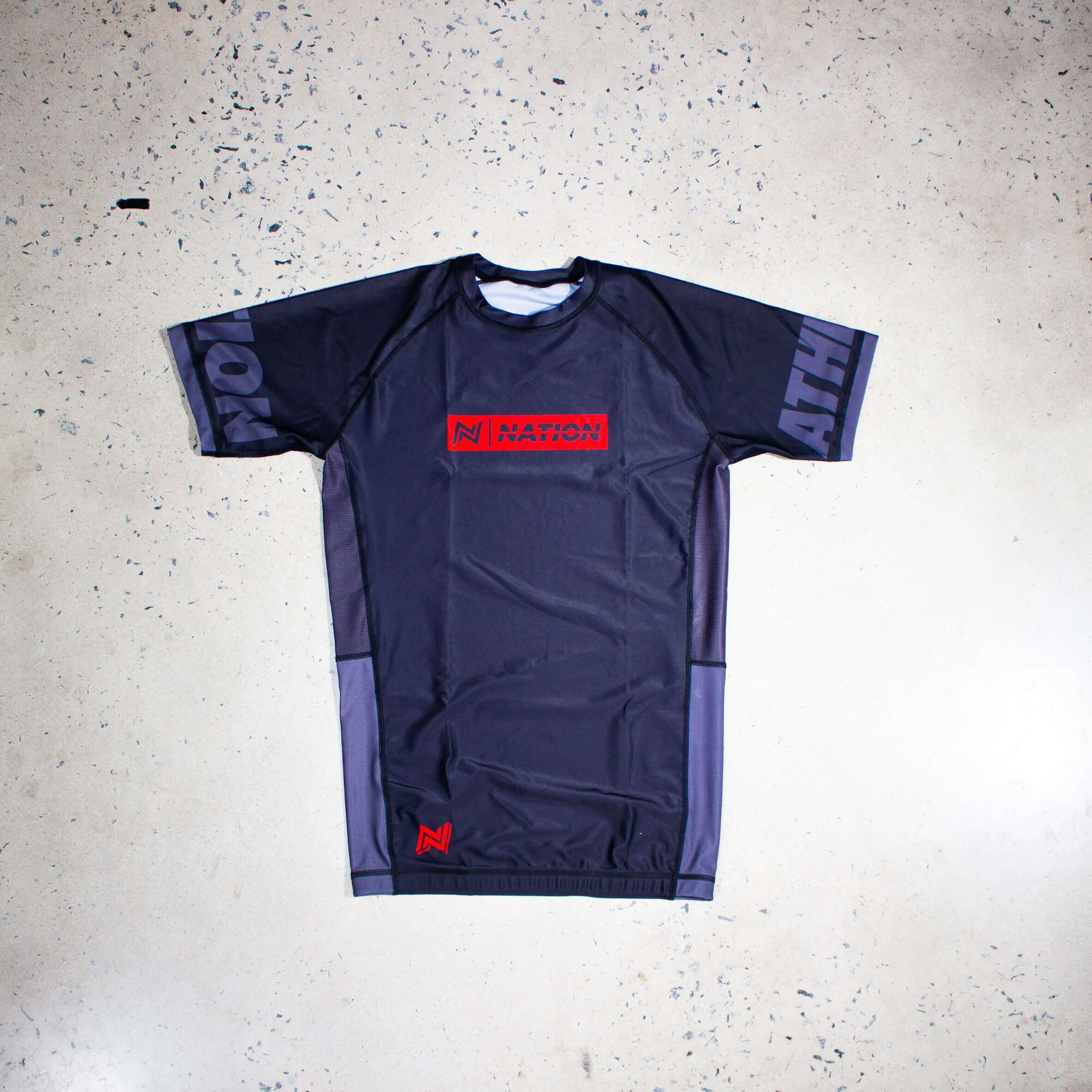 Black short sleeve youth Jiu Jitsu rash guard for kids, featuring moisture-wicking fabric and sublimated graphics for training and competition.
