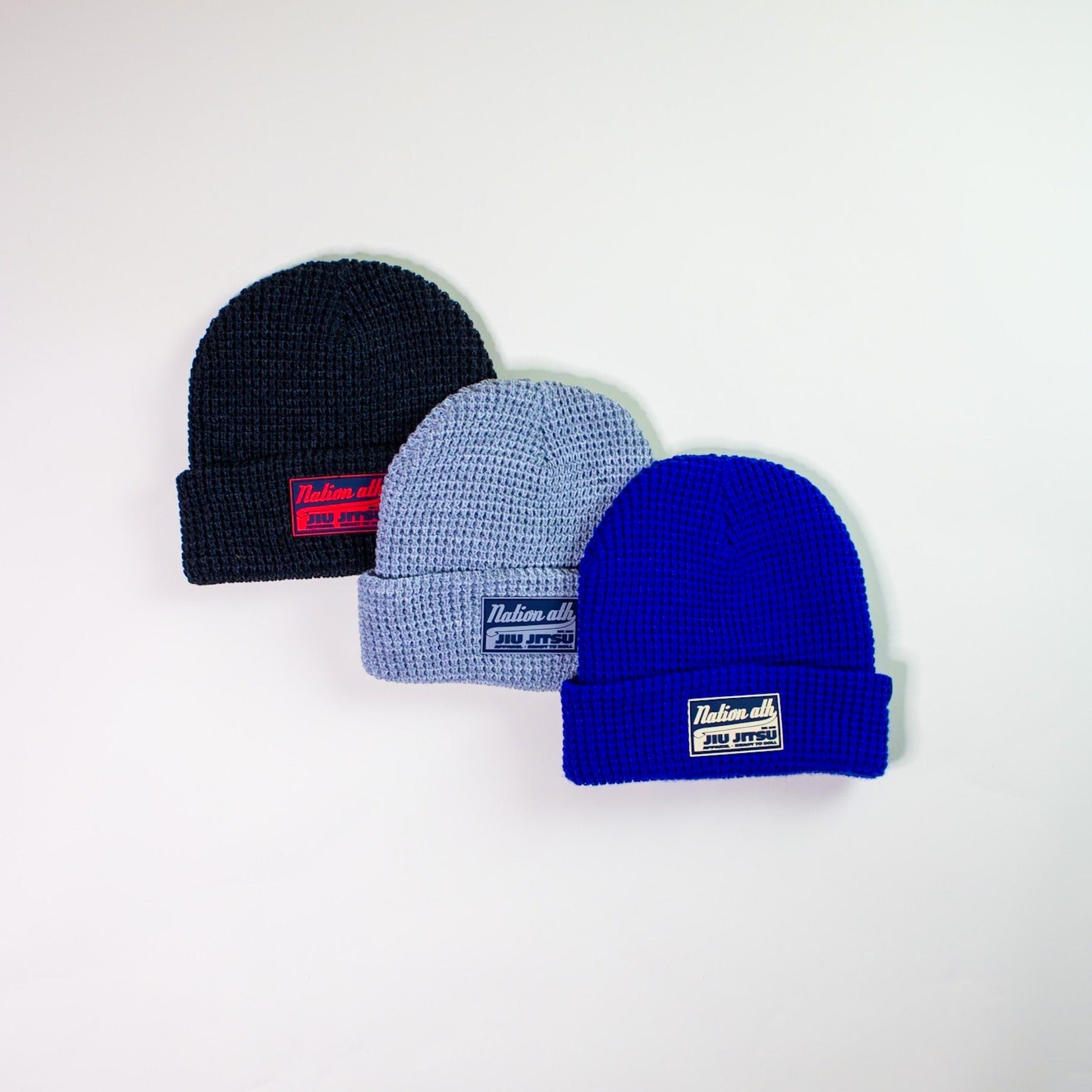 Jiu Jitsu beanies in waffle knit design in royal blue, charcoal, and light gray.