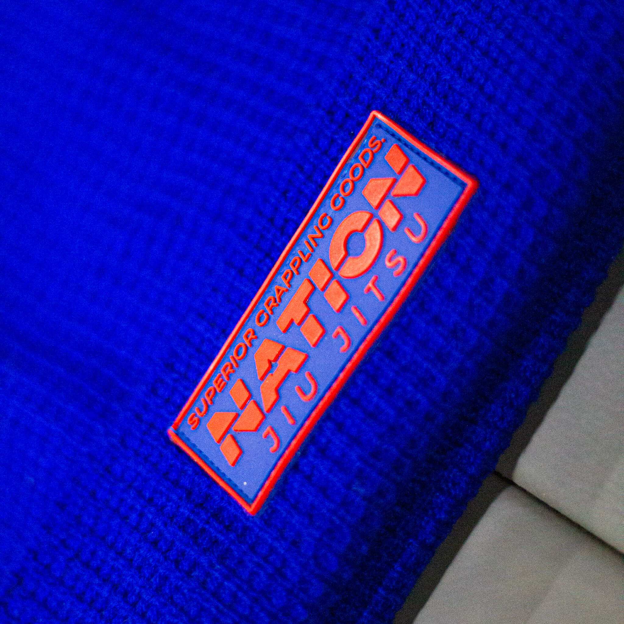 Blue gi with &#39;Nation Ju Jitsu&#39; logo on a blue background