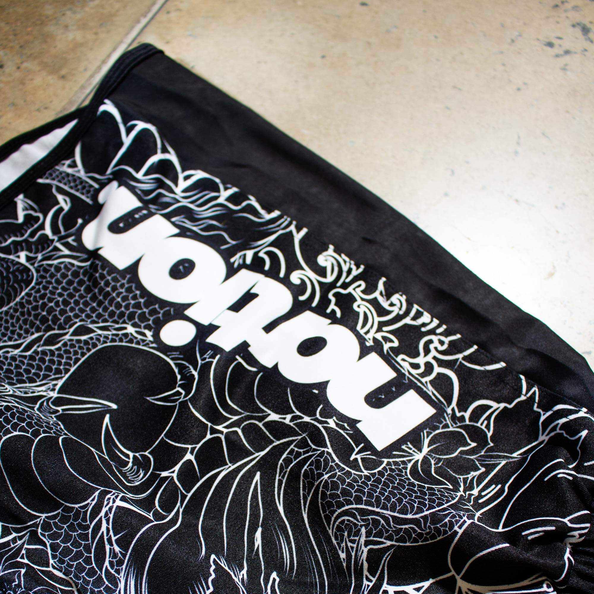 Rising Dragon Shorts logoWhite short sleeve BJJ rash guard with Rising Dragon design for No-Gi Jiu Jitsu and MMA.