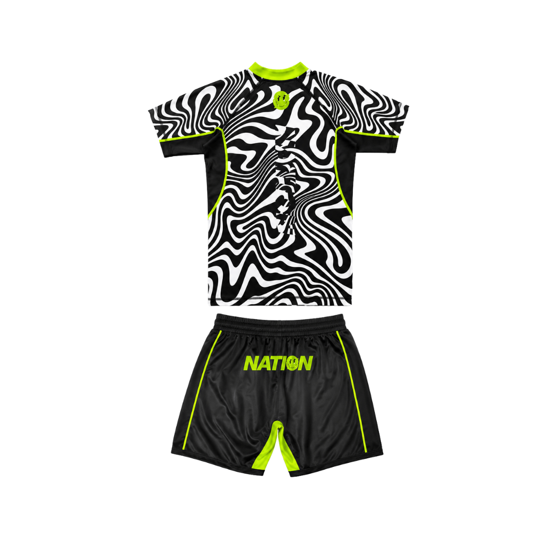 Black and white sports jersey with green accents and 'NATION' branding on shorts against a white background