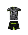 Black and white patterned shirt with green accents and black shorts with 'NATION' branding on a white background