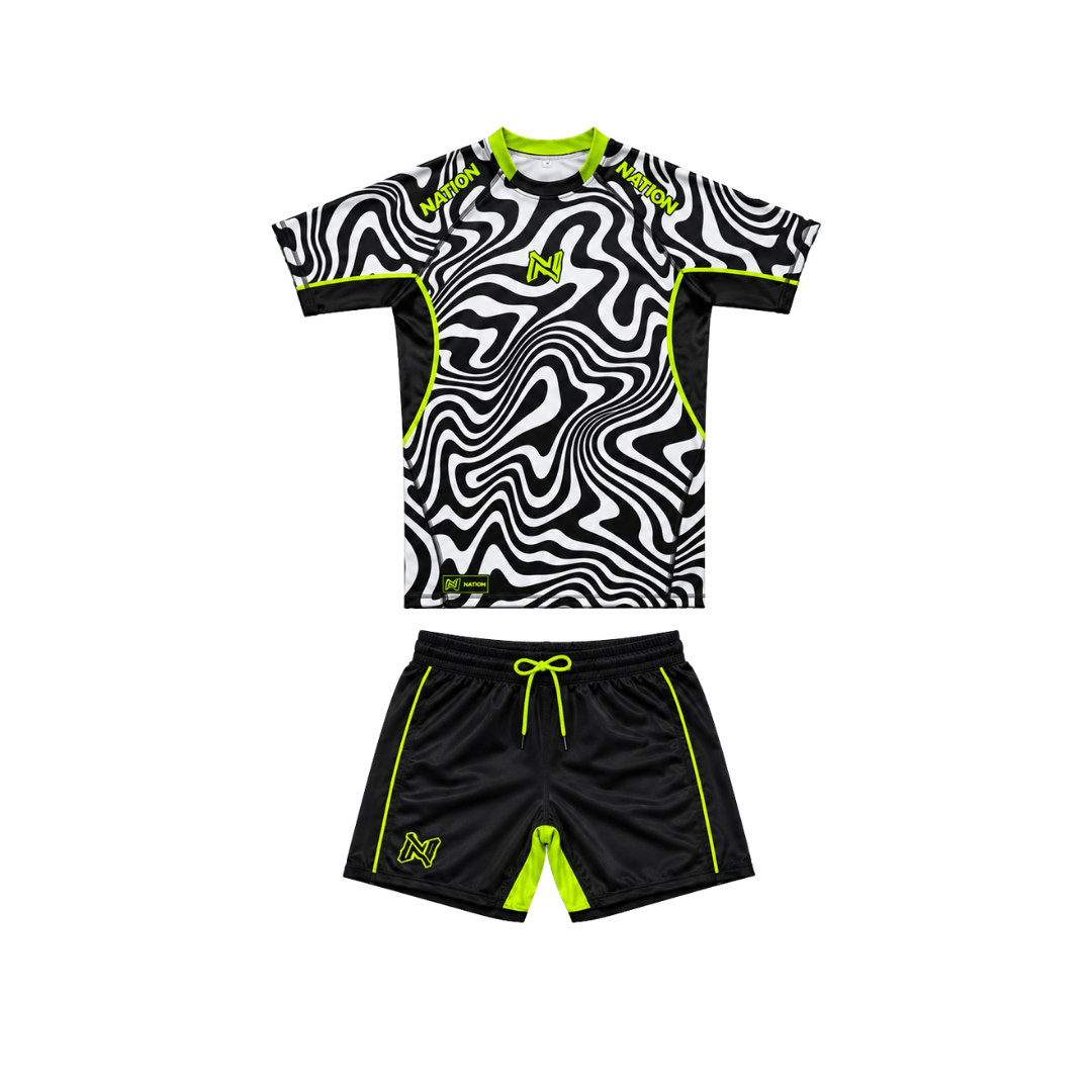 Black and white patterned shirt with green accents and black shorts with green accents on a white background