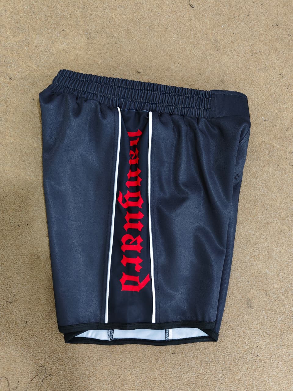 Black and white Vanguard Grappling Shorts by Nation Athletic designed for no-gi athletes with four-way stretch and moisture management