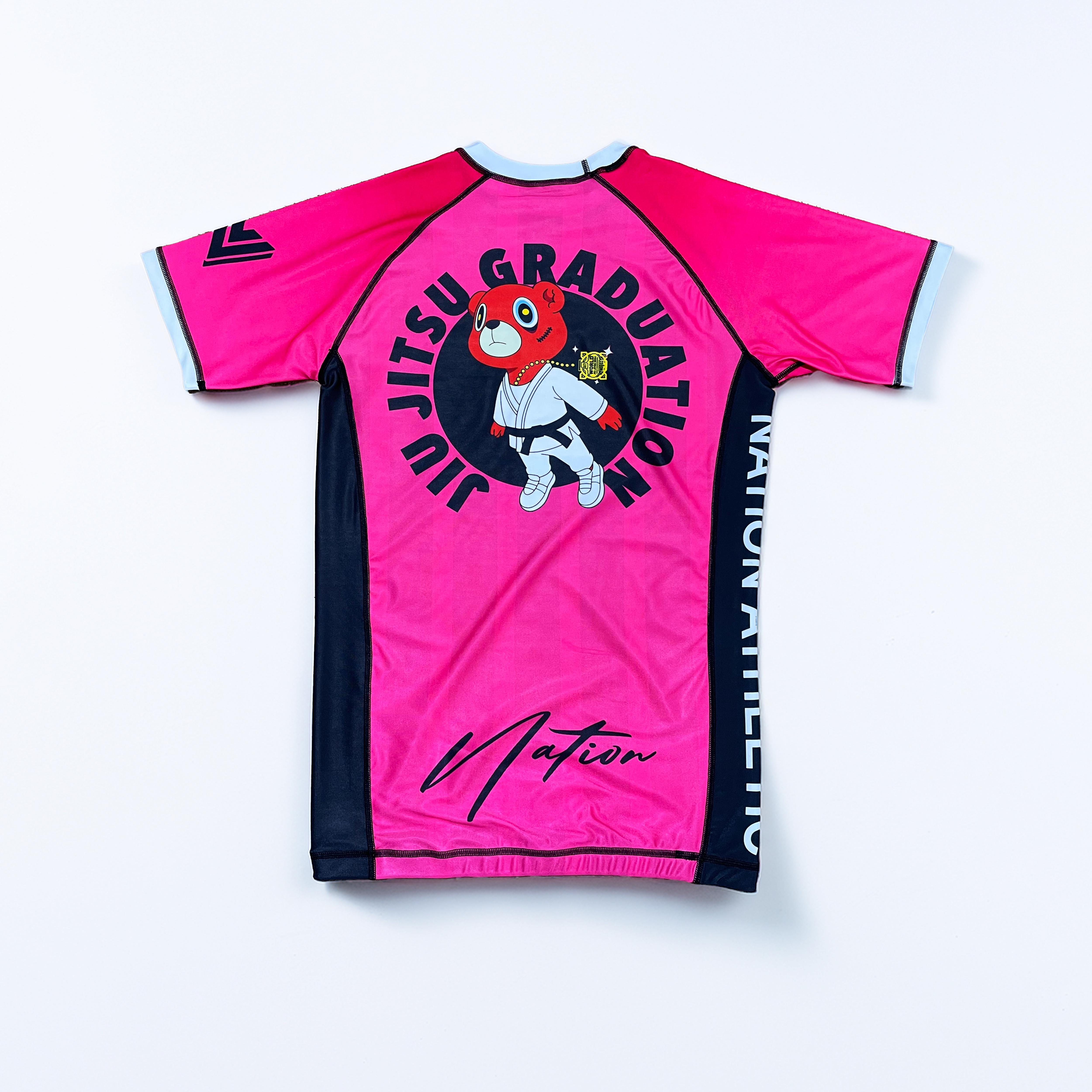 Pink and black Kanye BJJ Rash Guard with cartoon bear and Jiu Jitsu Graduation text, moisture-wicking compression top for no-gi training
