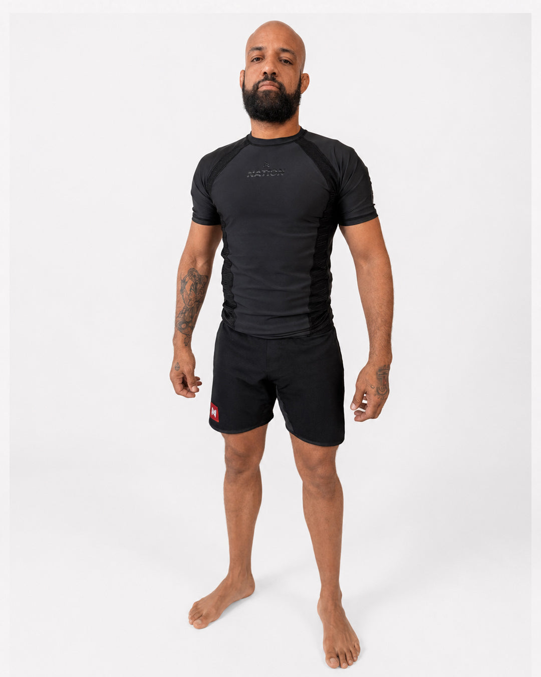 Man wearing a black athletic outfit on a white background