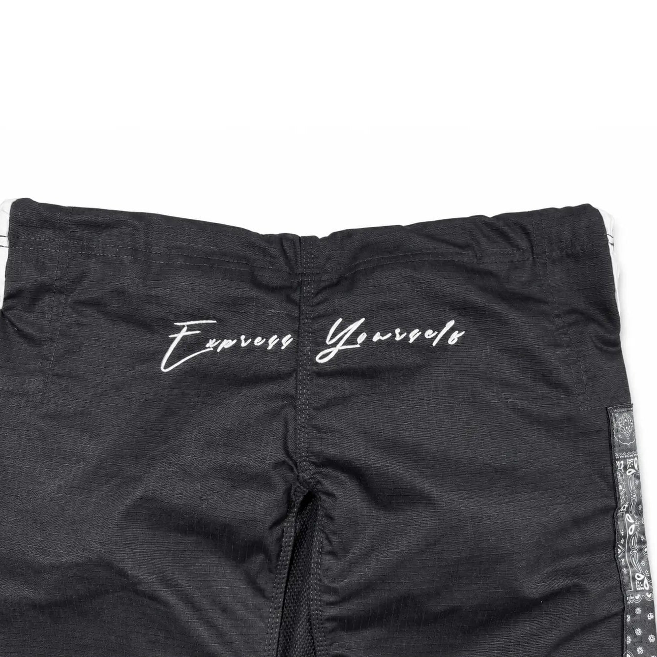 Black athletic bjj gi pants with 'Express Yourself' printed in white script across the back, featuring a patterned side stripe and a zippered front.