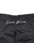 Black athletic bjj gi pants with 'Express Yourself' printed in white script across the back, featuring a patterned side stripe and a zippered front.
