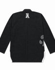 A black bjj gi kimono jacket shown from the back, featuring a white stylized 'NA' logo on the upper back and white circular paisley graphics on the lower back and side panels.