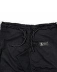 Black athletic bjj gi with a drawstring waist, a small black brand patch on the left hip, and a patterned side stripe, shown flat on a white background.