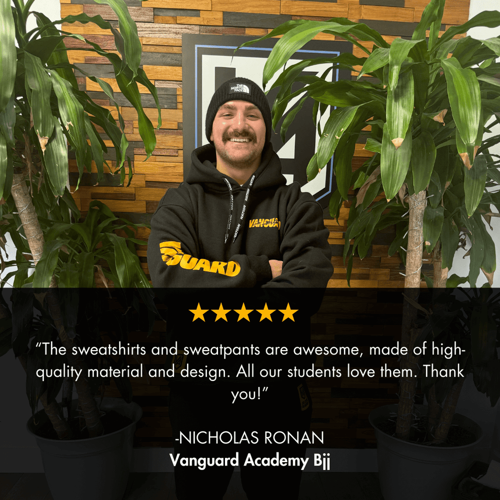 Person wearing a custom wholesale bjj black hoodie with nation athletic customer review overlayed