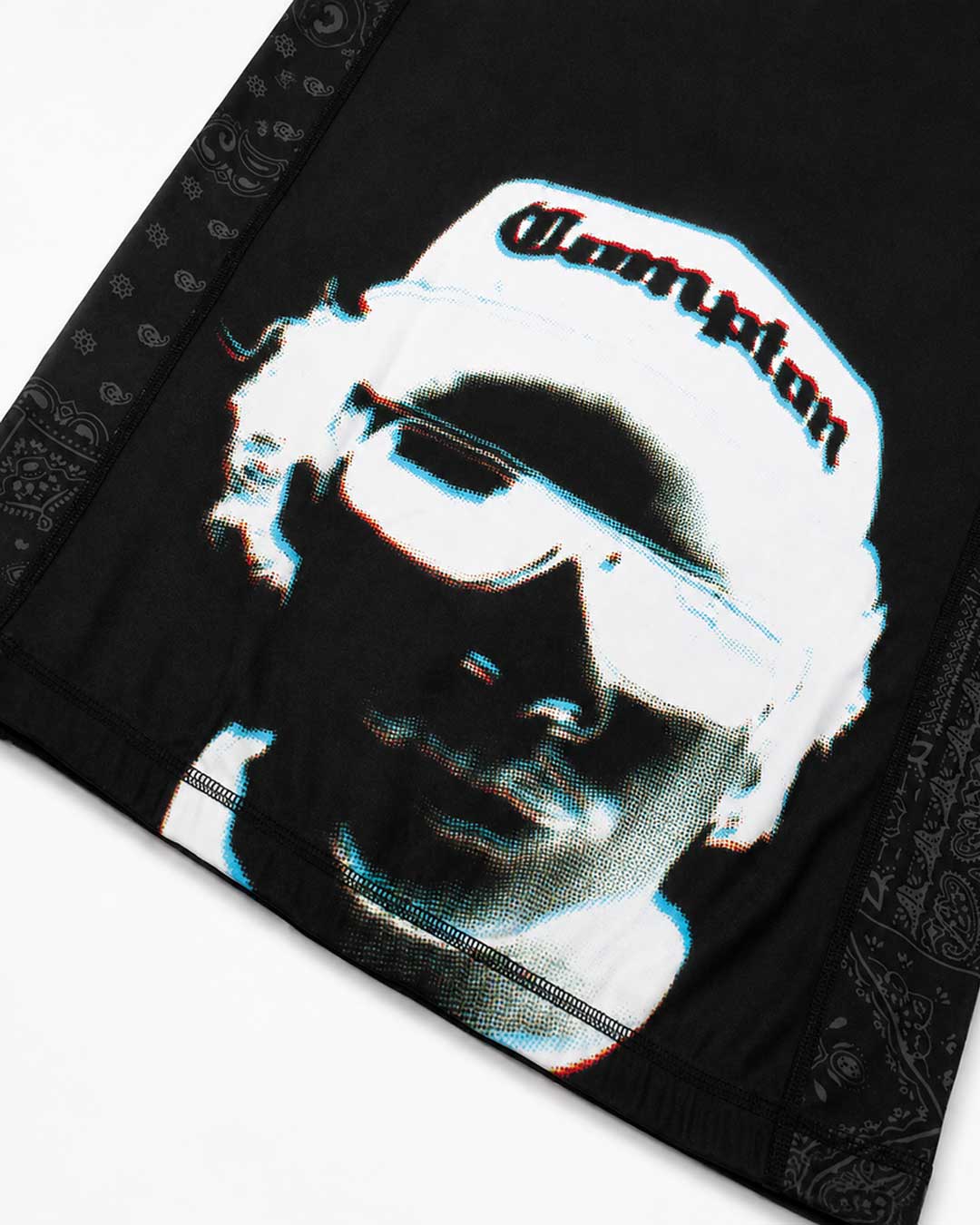 Black bandana featuring a stylized graphic print of a NWA's Eazy-E wearing a white Compton cap and white aviator sunglasses, with a black paisley border.