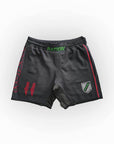 Black athletic shorts with red and green accents on a white background