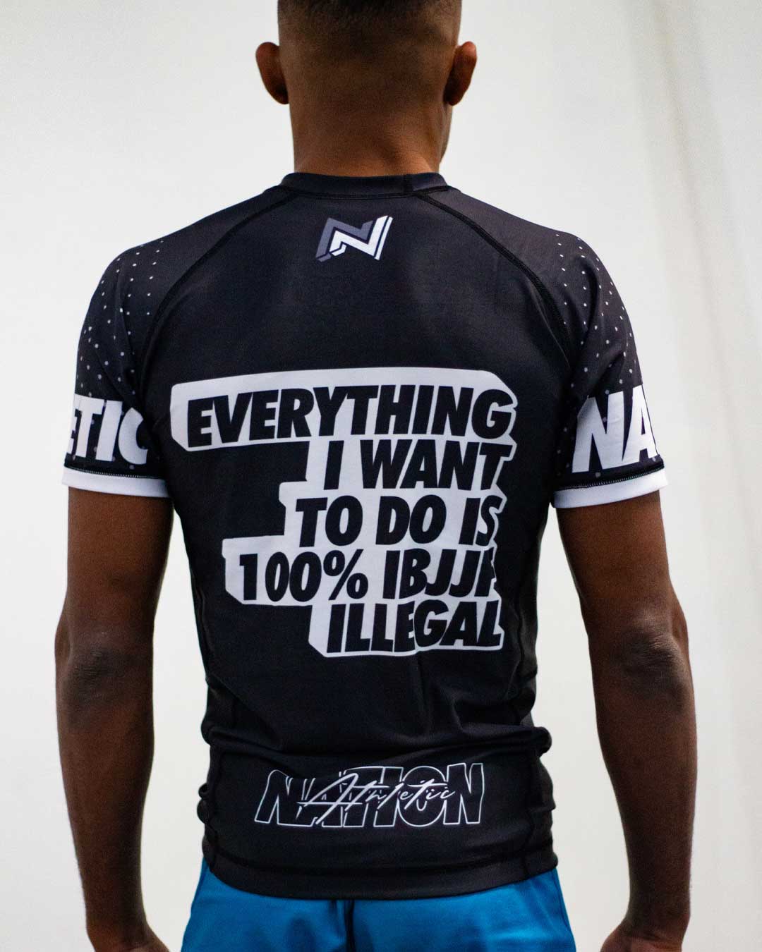 IBJJF Ranked Rash Guard with bold text design, short sleeve, durable spandex/polyester mix.